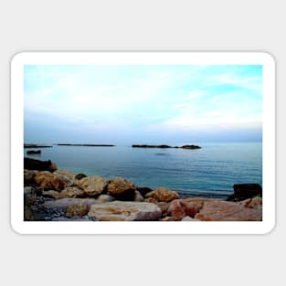 Calm Adriatic sea surrounded by massive rocks under the light blue sky Sticker